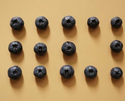 Blueberries arranged in a grid, with one missing.